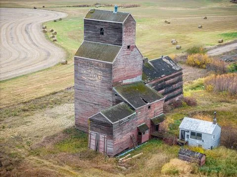 An old red grain elevator sits in a field Stock Photos