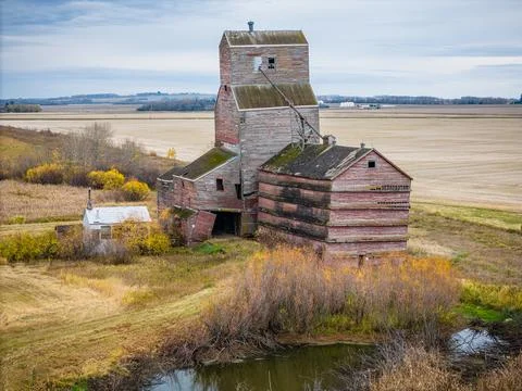 An old red grain elevator sits in a field Stock Photos