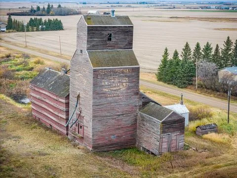 An old red grain elevator sits in a field Stock Photos