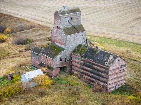 An old red grain elevator sits in a field Stock Photos