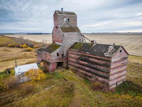 An old red grain elevator sits in a field Stock Photos