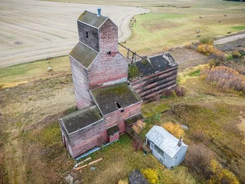 An old red grain elevator sits in a field Stock Photos