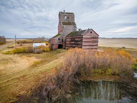 An old red grain elevator sits in a field Stock Photos