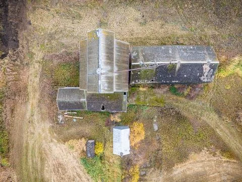 An old red grain elevator sits in a field Stock Photos