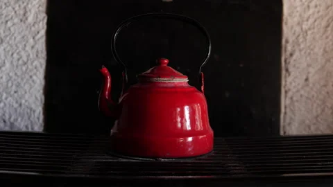 Old red metal kettle for boiling water Stock Footage 199261749