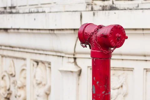 Old red metallic fire hydrant plug Stock Photos