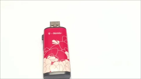 Old red mobile broadband USB modem with floral design Video stock 335804720