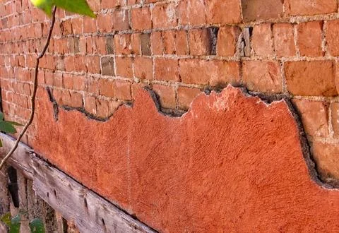 Old red plaster falling off of a brick wall. Jerome, Arizona. Stock Photos