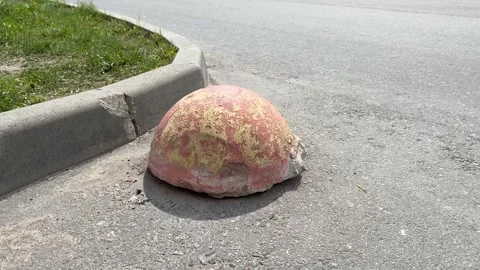 Old red restrictive hemispheres on the asphalt road in the parking area of the Stock Footage 301136004