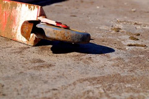 Old red rusty abandoned scooter lying on the concrete floor. Stock Photos