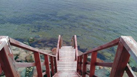 Old red stairs going down on Canadian costline Stock Photos