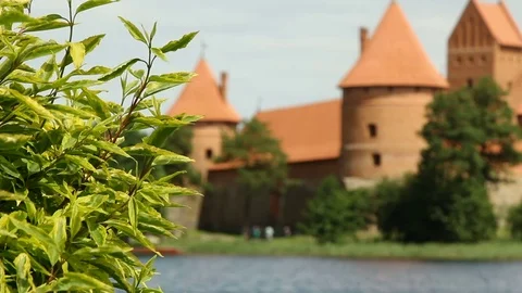 Old red stone castle. On the shore of beautiful lake. Crowd of people , tourist Stock Footage 79103118