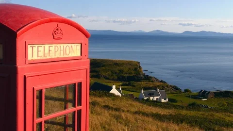 Old red telephone booth in a remote place in Scottish Highlands. Two shots Stock Footage 97522394