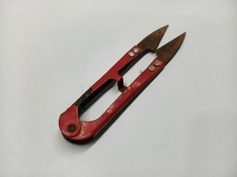 Old red thread snips on white background Stock Photos