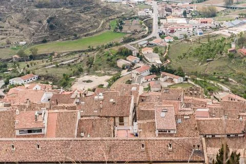 Old red tile roofs of different shades and heights Stock Photos