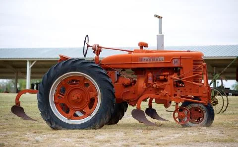 Old red tractor in a field Stock Photos