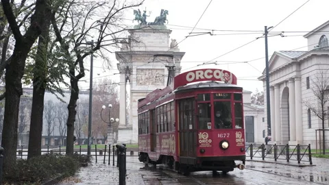 Old red tram passes by the centre of the Old Town of Milan Arch of Peace Video stock 165849552