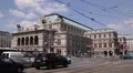 Old Red Tram Passing Crossing Intersection Cars Traffic Jam Vienna State Opera HD Footage