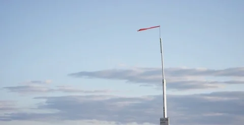 Old red warning flag flying in wind 動画素材 77338939