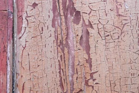 Old red weathered paint on rustic wooden panel Stock Photos