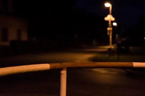 Old red-white railing at night by the road Stock Photos