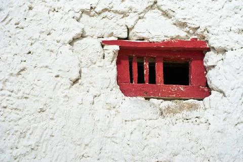 Old red window frame on white wall at Buddhist monastery. India, Ladakh, L... 库存照片