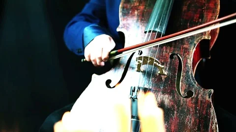 Old red wood cello playing in a candles light - camera moving on a dolly Vídeo Stock 72888045
