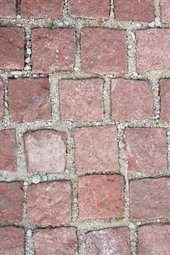 Old reddish stone pavement mounted on gravel Stock Photos