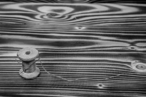 The old reel of thread and a needle. Stock Photos
