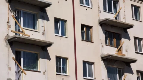 Old residential building facade multiple windows some open some closed damaged Stock-Footage 342230859