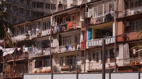 Old residential building with laundry drying on balconies Видео 334153335