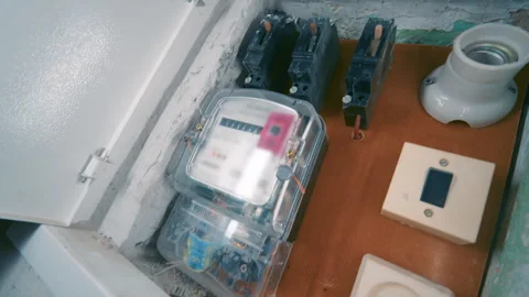 Old Residential Electric Panel Interior with Meter, Circuit Breakers and Socket Stock Footage 333082305