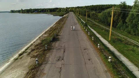 An old retired couple, a man and a woman, are running in the distance along the Video stock 258689169