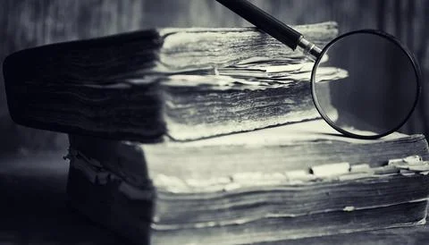An old retro book on the table. An encyclopedia of the past on an old woode.. Stock Photos