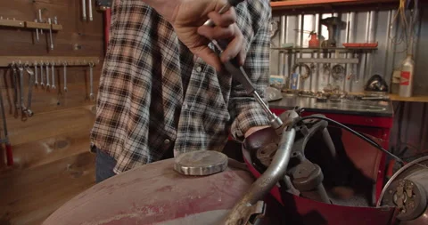 Old retro classic motorcycle disassemble for restoration in repair shop garage Stock Footage