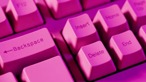 Old retro keyboard close-up. Computer buttons in neon pink light top view. 库存影片 204925942