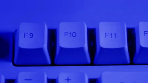 Old retro keyboard close-up. Computer buttons in neon blue light top view. Stock Footage 205901583