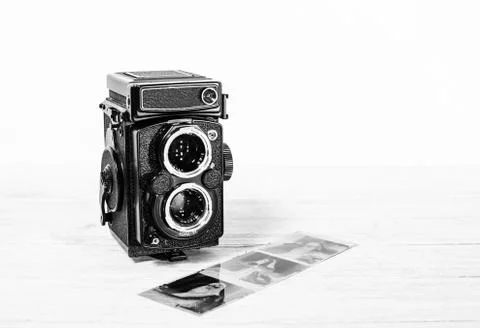 Old retro medium format camera and film negatives on white background Stock Photos
