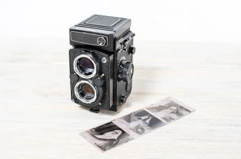 Old retro medium format camera and film negatives on white background Stock Photos
