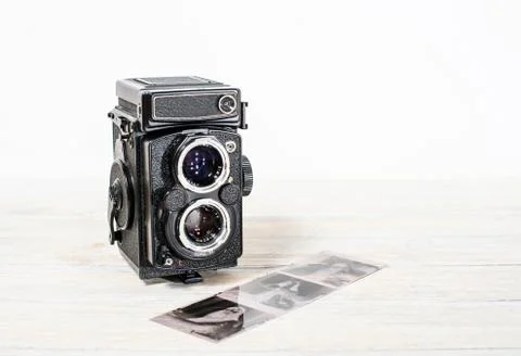 Old retro medium format camera and film negatives on white background Stock Photos