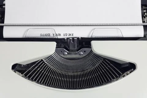 Old retro obsolete white typewriter with close-up typing text Share your Stor Stock Photos
