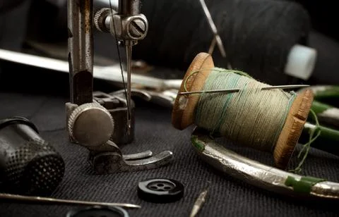 Old retro sewing machine, needle with thread, scissors and thimble. Tailor Stock Photos
