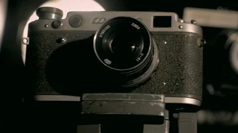 Old retro style camera sliding in the dark studio white violet lights indoors Stock Footage 64853953