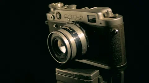 Old retro style camera with the white light in the dark studio indoors Stock Footage 64856013