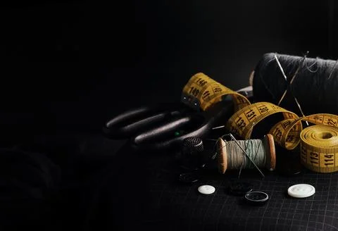 Old retro tailor's tools for sewing clothes. Centimeter, scissors, thimble Stock Photos