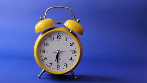 Old retro yellow alarm clock that triggers the alarm Stock Footage 137973578