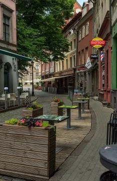 Old Riga city tiny pavement street outdoor cafe Stock Photos