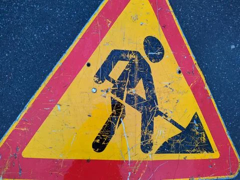 Old road sign work in progress closeup photo Stock Photos