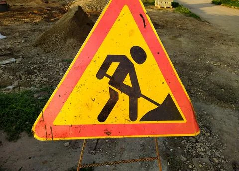 Old road sign work in progress closeup photo. Stock Photos