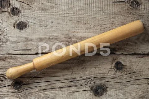 Old Rolling Pin On A Wooden Board